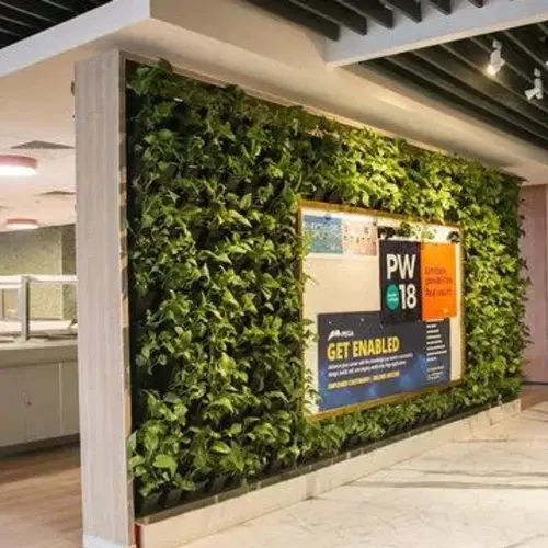 Modern entrance with vertical garden and potted plants