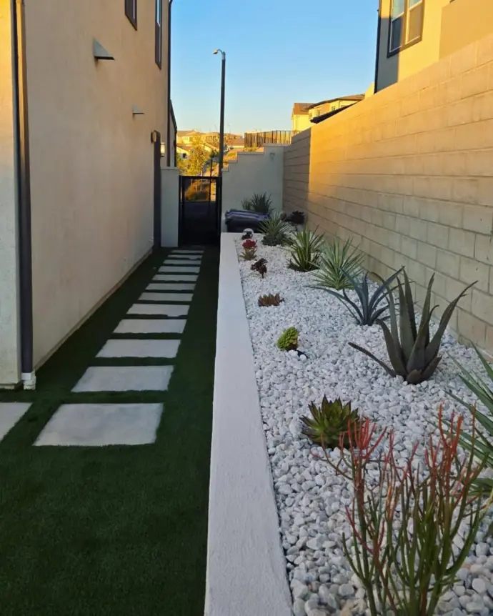 Pathway decorated with white flowers and outdoor lighting