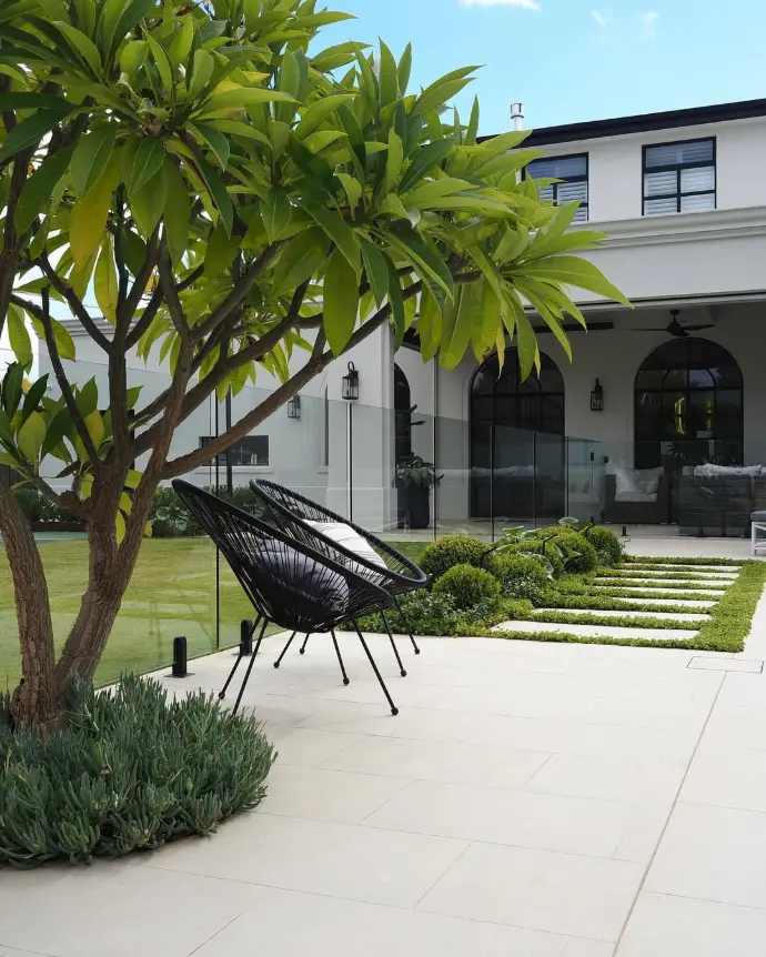 Garden area with pathway tiles and trimmed plants